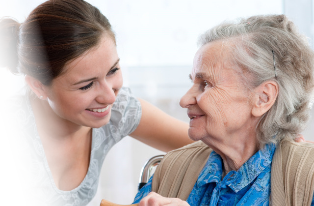 Care worker assisting elderly lady